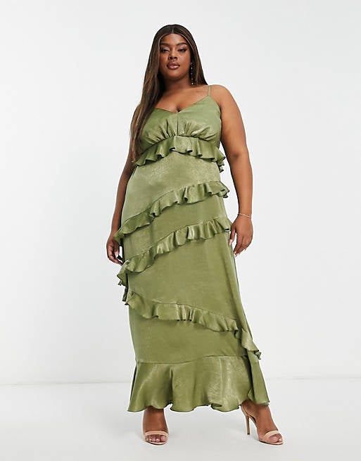 a model poses in the green dress  with five tiers of ruffles