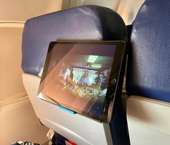 The holder holding an iPad behind an airplane seat
