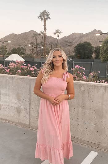 reviewer in pink maxi dress
