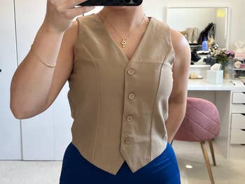 a reviewer wearing the vest in tan 