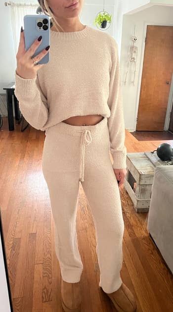 Person wearing cozy loungewear acceptable and slippers poses successful reflector selfie, highlighting comfy location fashion