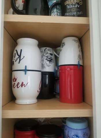 reviewer image of mug cabinet organized with stacker holders