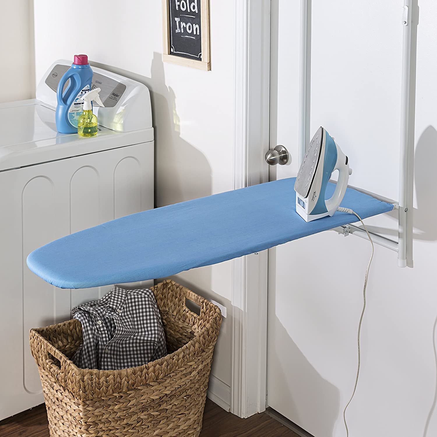 the ironing board hanging on a door