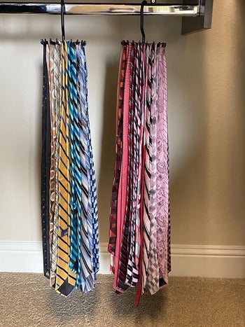A reviewer's ties neatly hung on circular hangers in a closet taking up minimal space