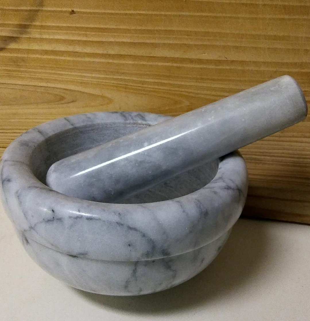 Small marble mortar and pestle set on table 