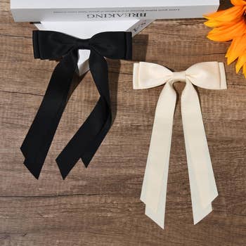 Two bow ties, one black and one ivory