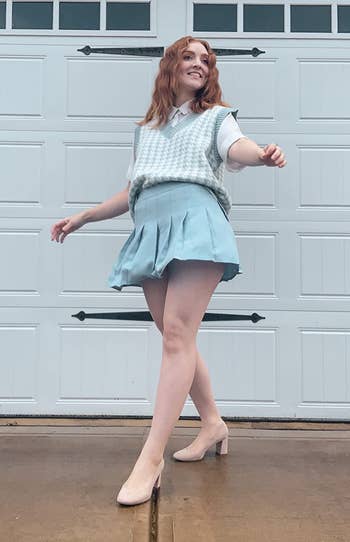 reviewer wearing the skirt in blue