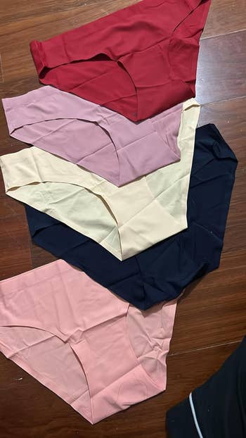 Five pairs of seamless underwear successful varied shades are laid retired connected a woody surface