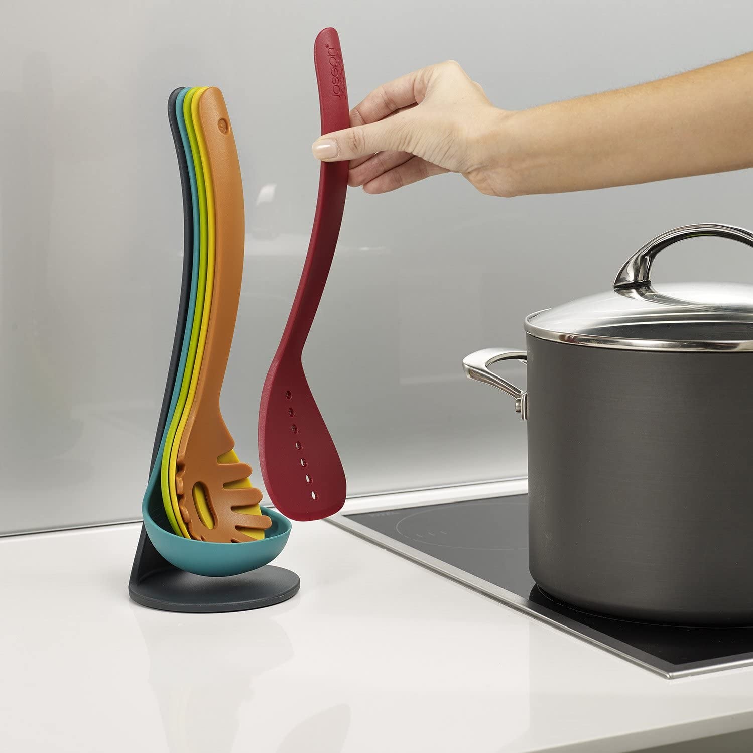 The utensils hanging and nested together in different rainbow colors
