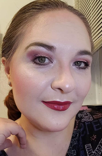 Reviewer with blush and highlighter on their cheek