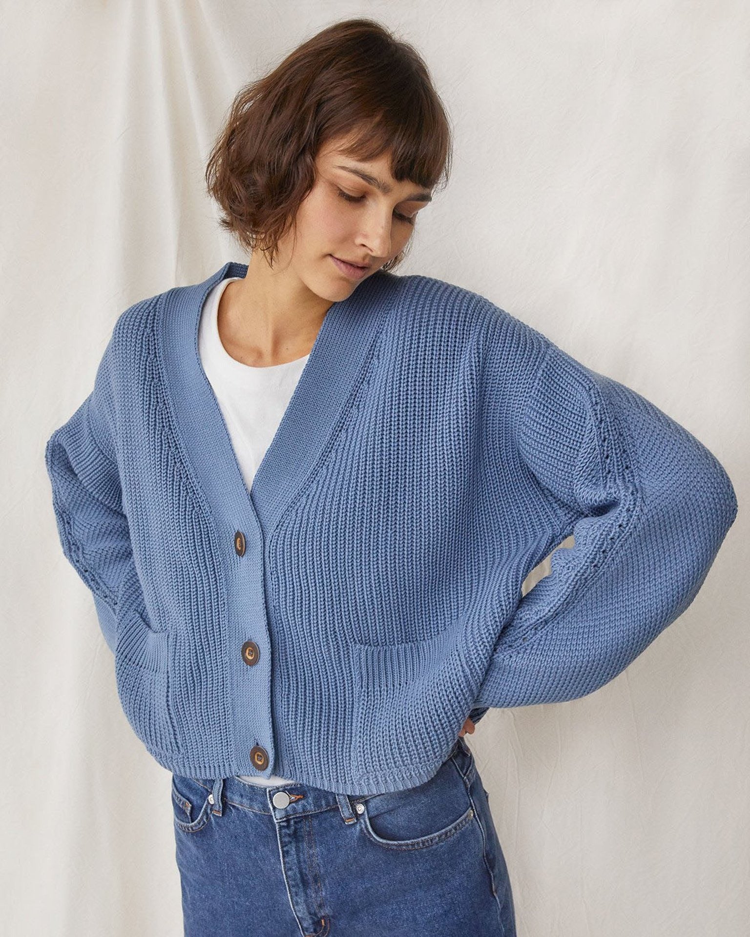 model in blue cardigan