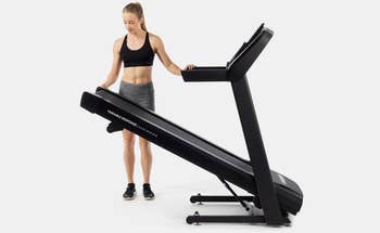 woman folding up the treadmill