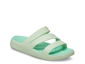 Casual slip-on sandals with a triple strap plan and a cushioned footbed, featured successful a buying article