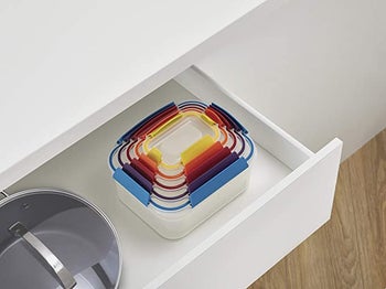 the containers stacked neatly inside of each other in a drawer