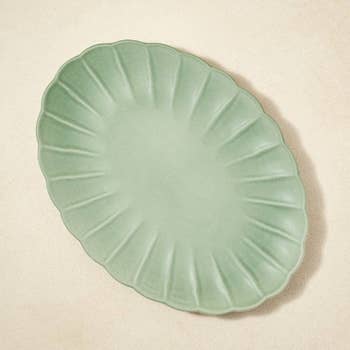product image of green scalloped melamine plate