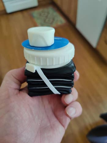 Person holding the collapsed water bottle