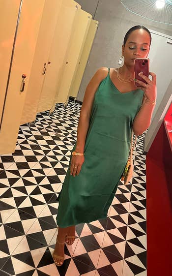 a reviewer wearing the green dress