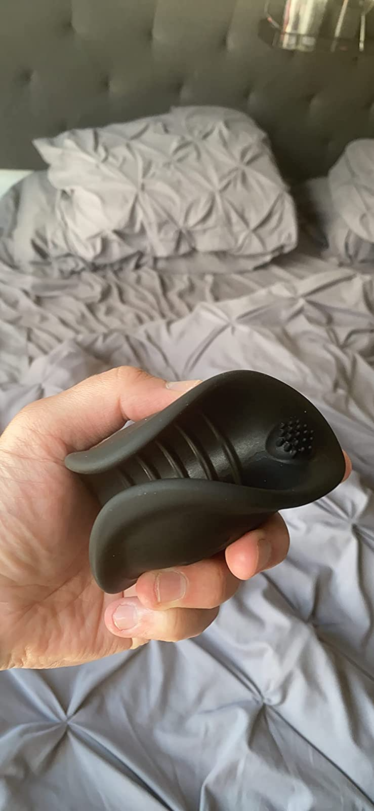 Reviewer holding black ribbed stroker