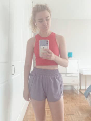 BuzzFeed editor Emma Lord in same style bike shorts and a pink running crop top
