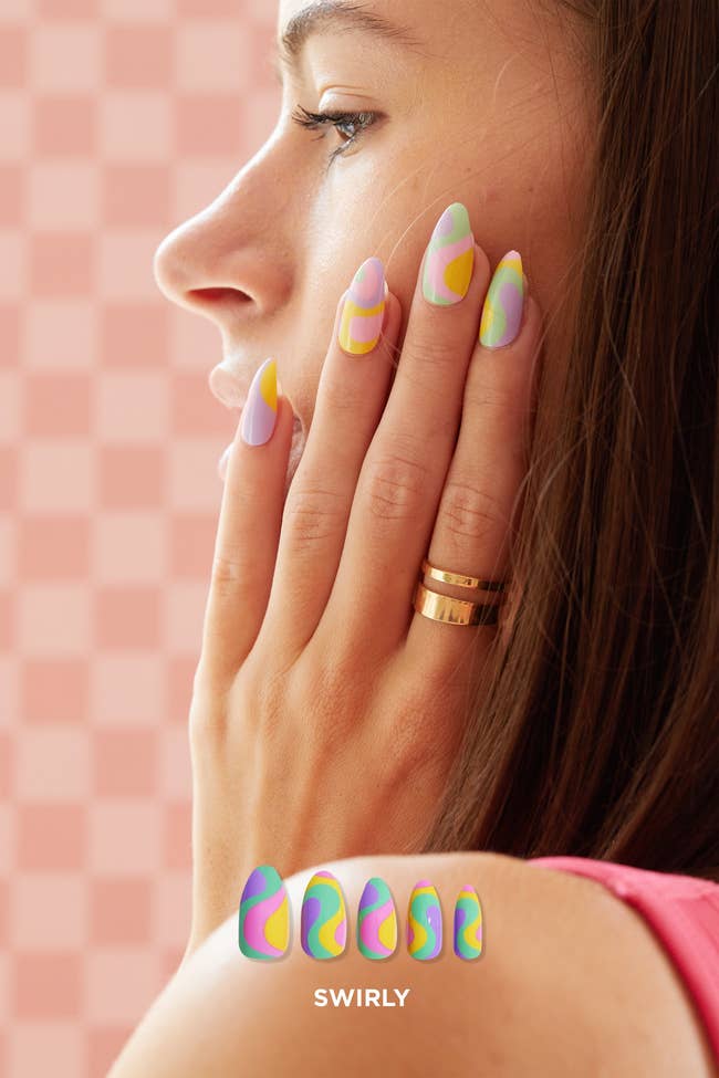 model in pink mint yellow and purple swirl design nails
