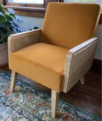 reviewer photo of the orange rattan armchair