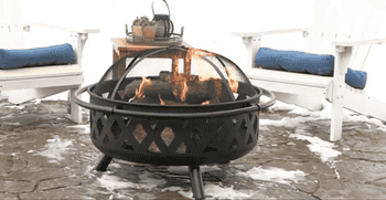 gif of fire pit outside in the snow with fire burning in it