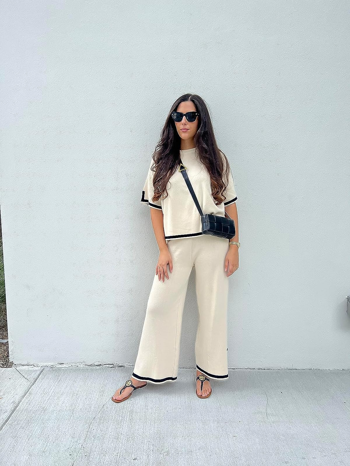 reviewer wearing the cream and black set