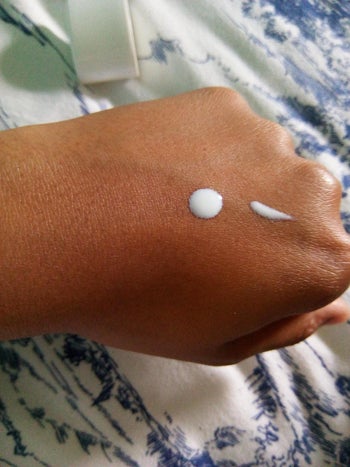 reviewer with sunscreen on their hand
