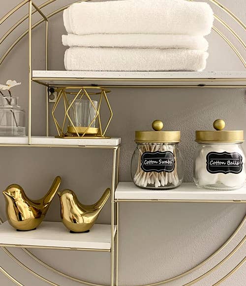 two birds in gold on a shelf