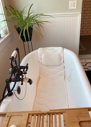 the bath pillow in a reviewer's tub