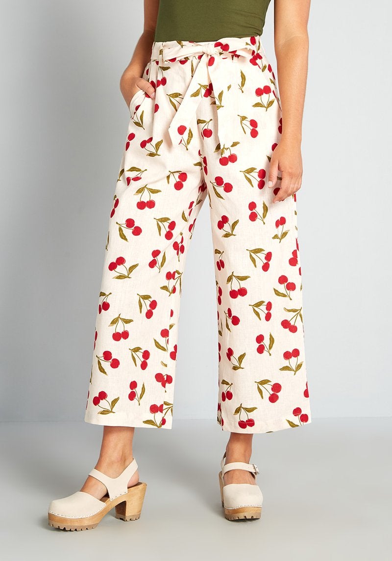model wearing the cream and cherry printed belted pants