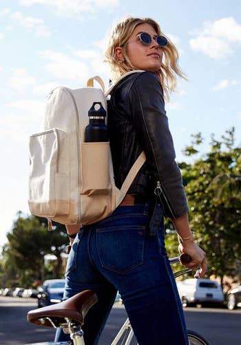 model wearing the backpack in beige