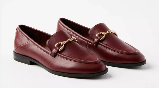 Close up of the loafers in oxblood with a gold horsebit detailing and black soles
