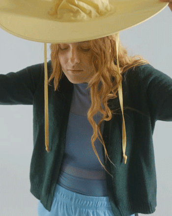 GIF of model taking off the hat and packing it into its travel pouch