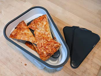reviewer image of the container with slices of pizza in it