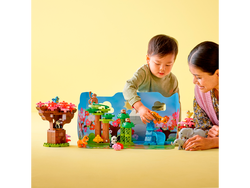 Child and adult model playing with Lego set for scale