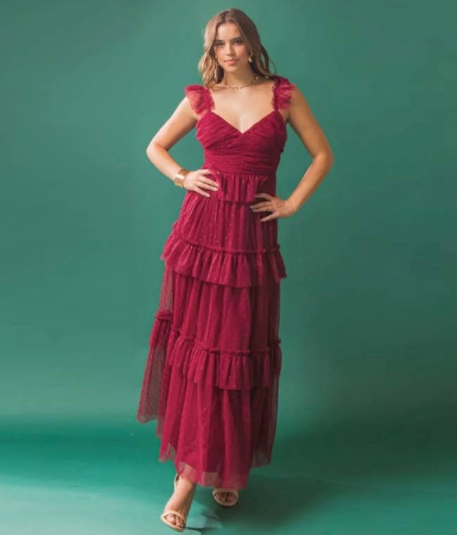 Model is wearing a red tiered maxi dress