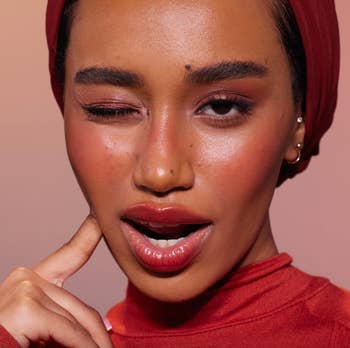 a model wearing the shade rebel red