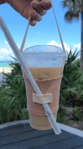 a gif of the cup holder bolding a large iced coffee
