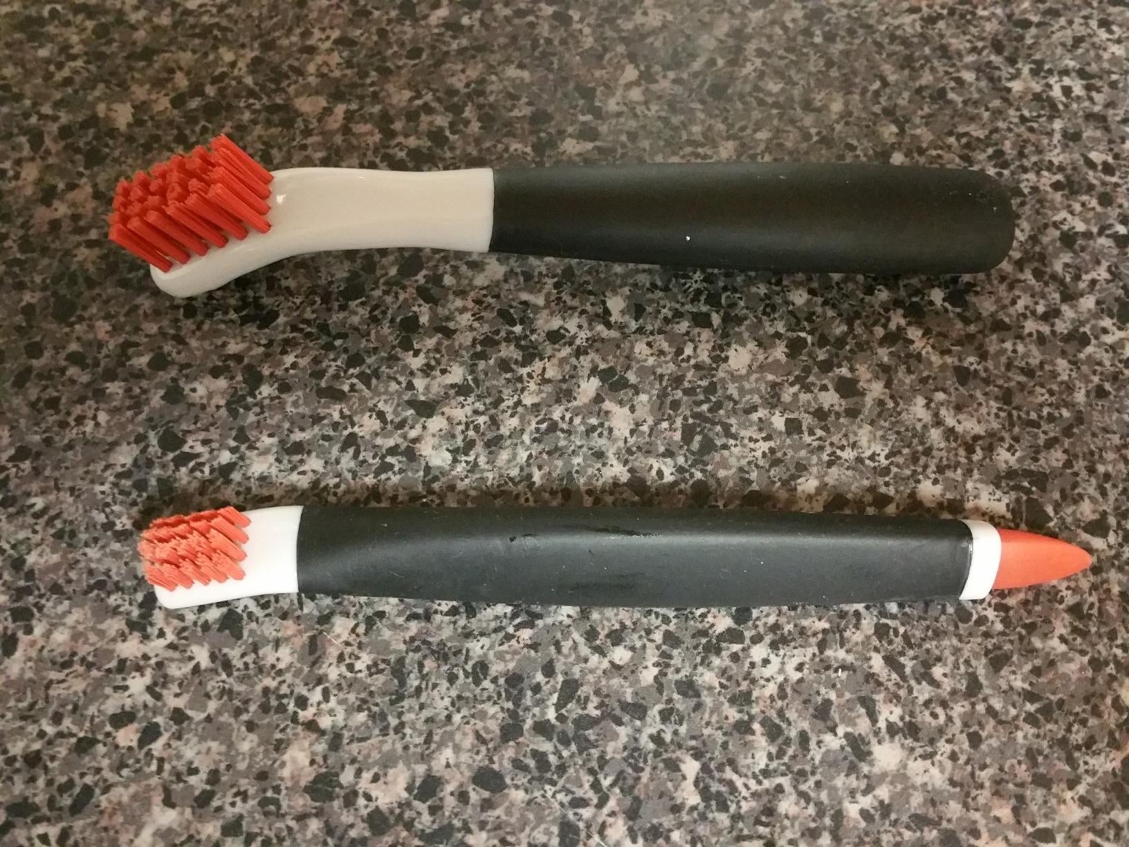Reviewer image of two red, white, and black brushes on top of counter