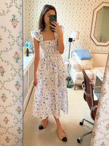 model in a white and blue floral nap dress