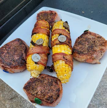 the cooked bacon-wrapped corn with the bacon holders still keeping the bacon strips intact
