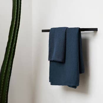 the slate colored towel set hanging from a towel bar