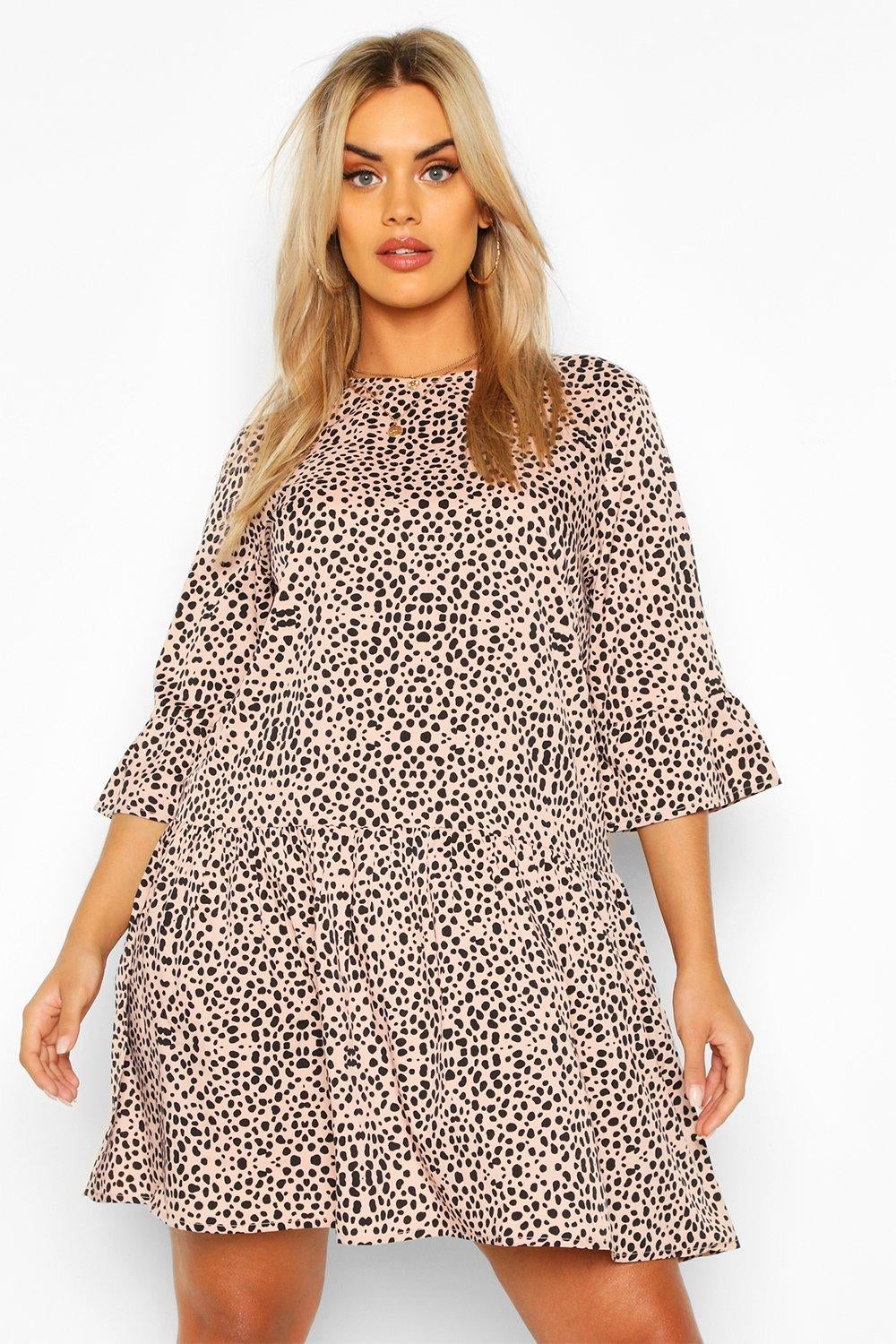 a model in the tan and black dotted smocked dress