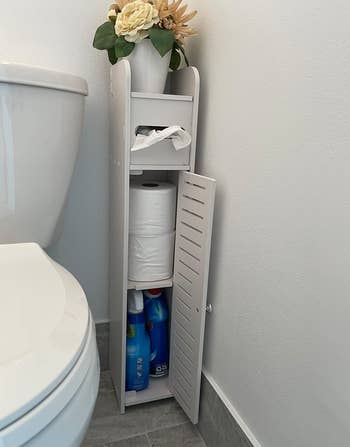 same reviewer's photo of the storage cabinet with its door open to show its shelf space inside