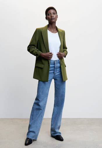 model in the green blazer with blue jeans and a white tee