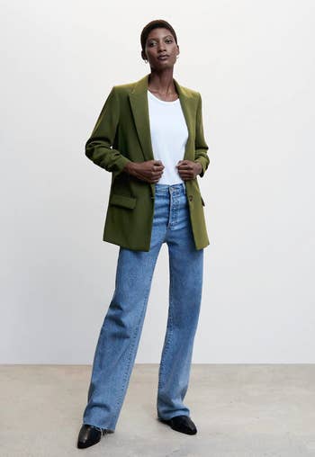 model in the green blazer with blue jeans and a white tee