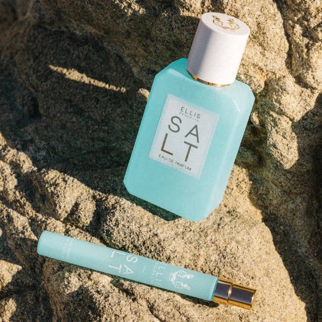 Two bottles of Ellis Brooklyn SALT eau de parfum connected  a rocky surface, featuring a full-size vessel  and a question   spray size