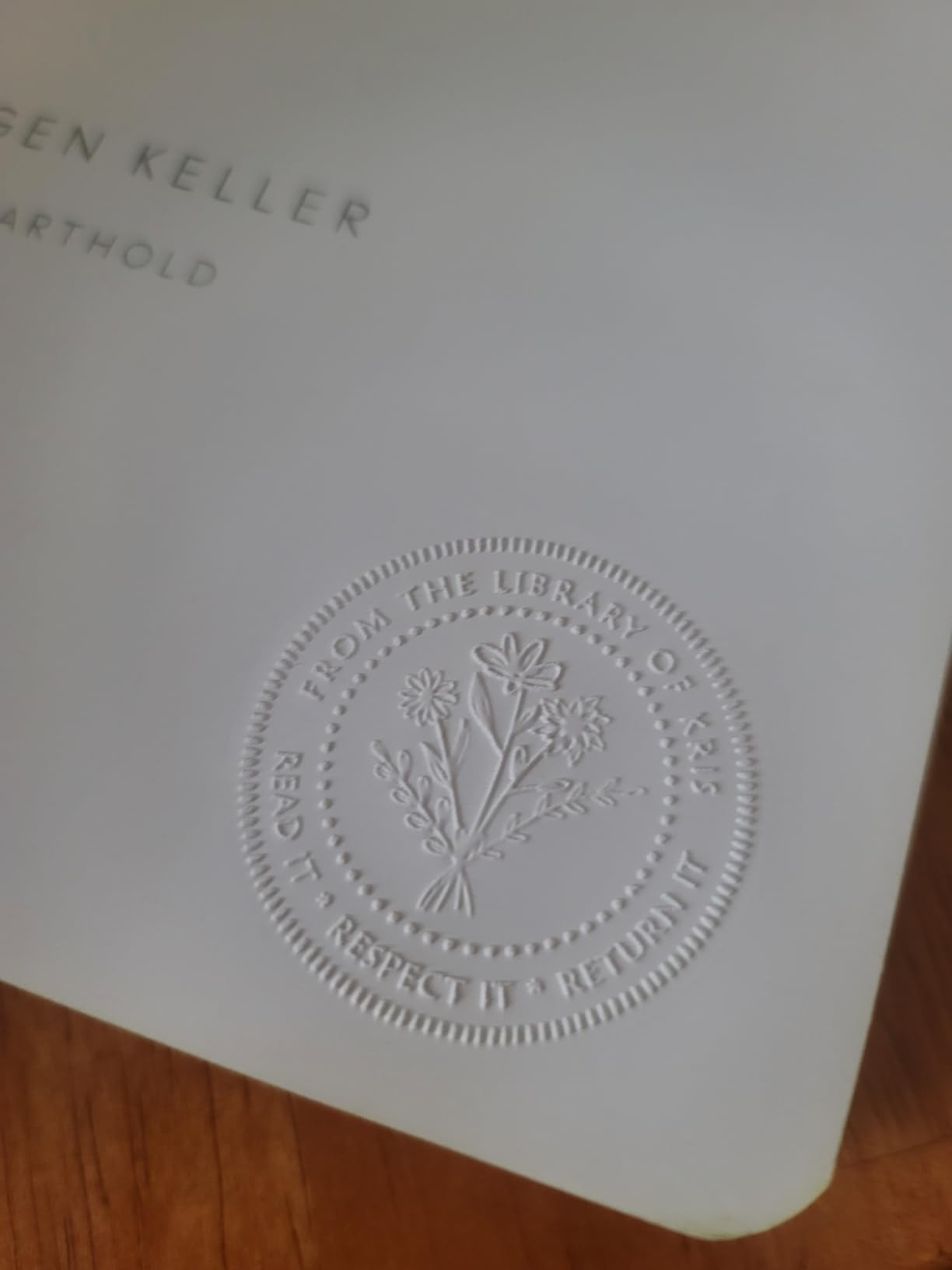 Embossed seal on a book cover reads: 