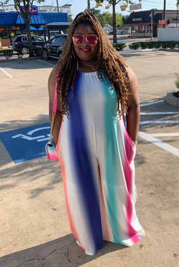 a different reviewer wearing the jumpsuit in blue, green, and pink